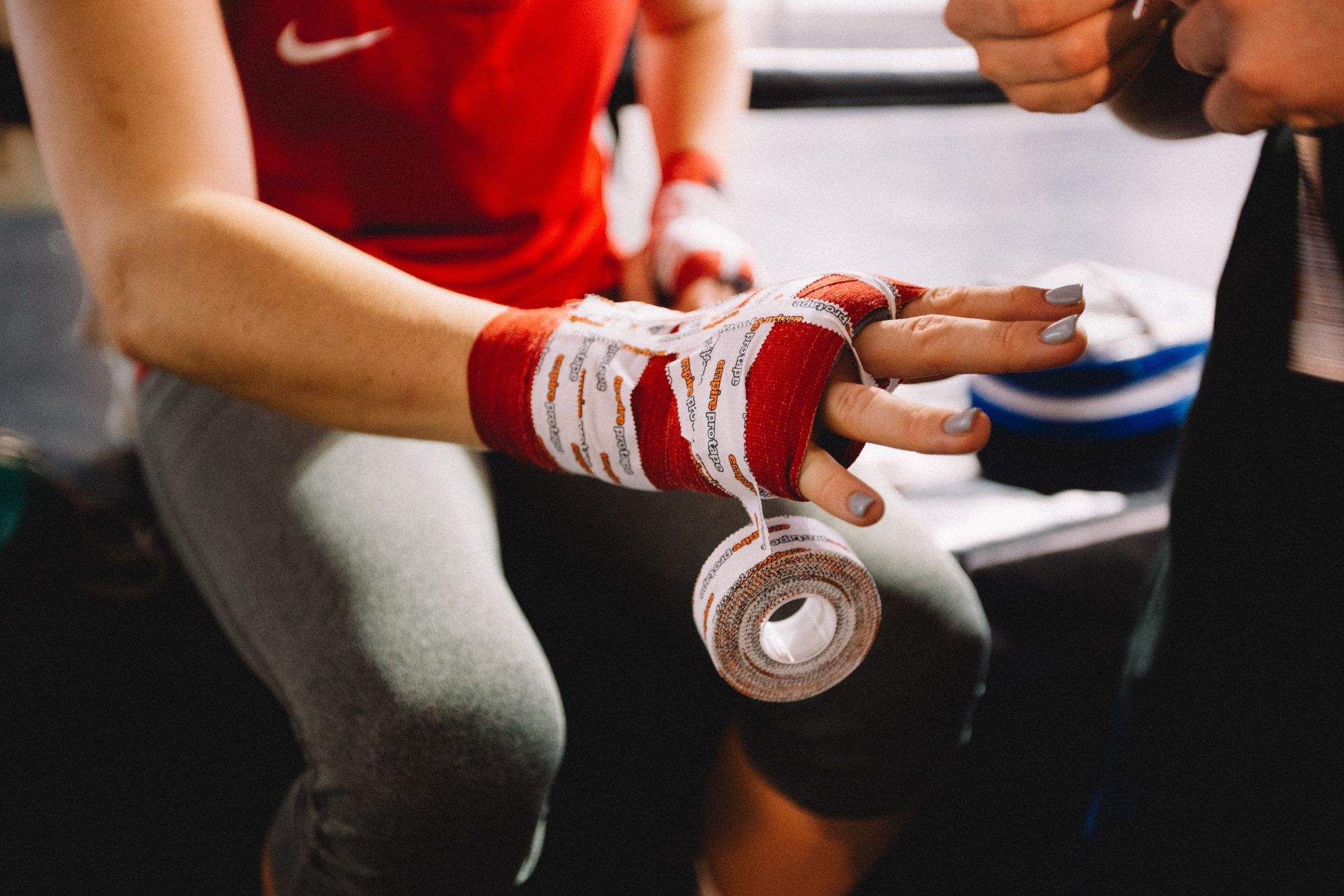 Female boxer's hand being taped up